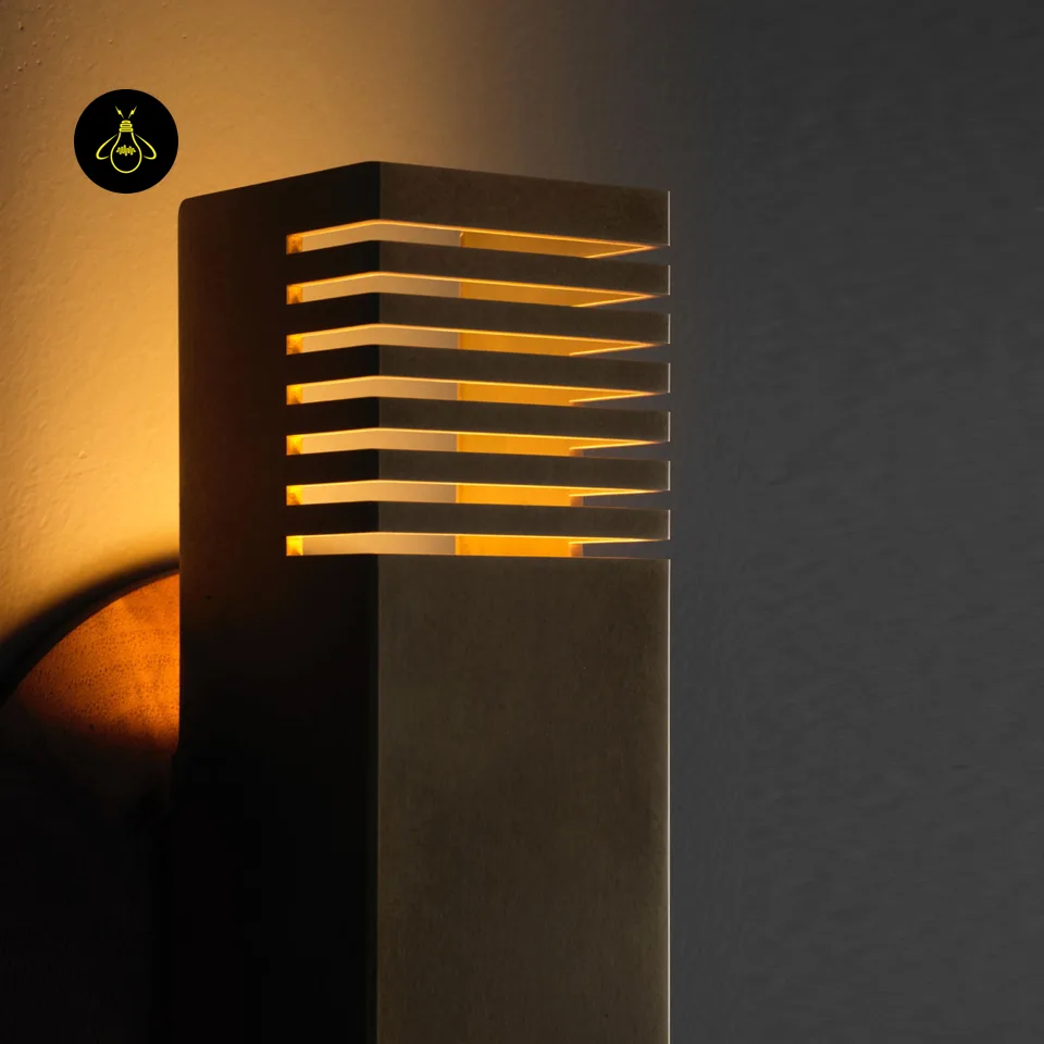 Boundary Wall Light – Brass-Finish Up & Down Sconce, 10.5 in 3 Close-up of boundary wall light brass milled slots emitting warm light