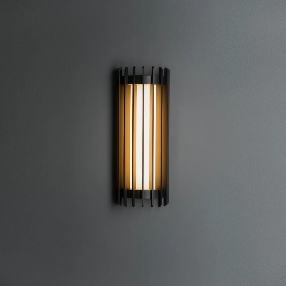 Modern outdoor wall sconce in matte-black slatted steel glowing through a frosted glass cylinder