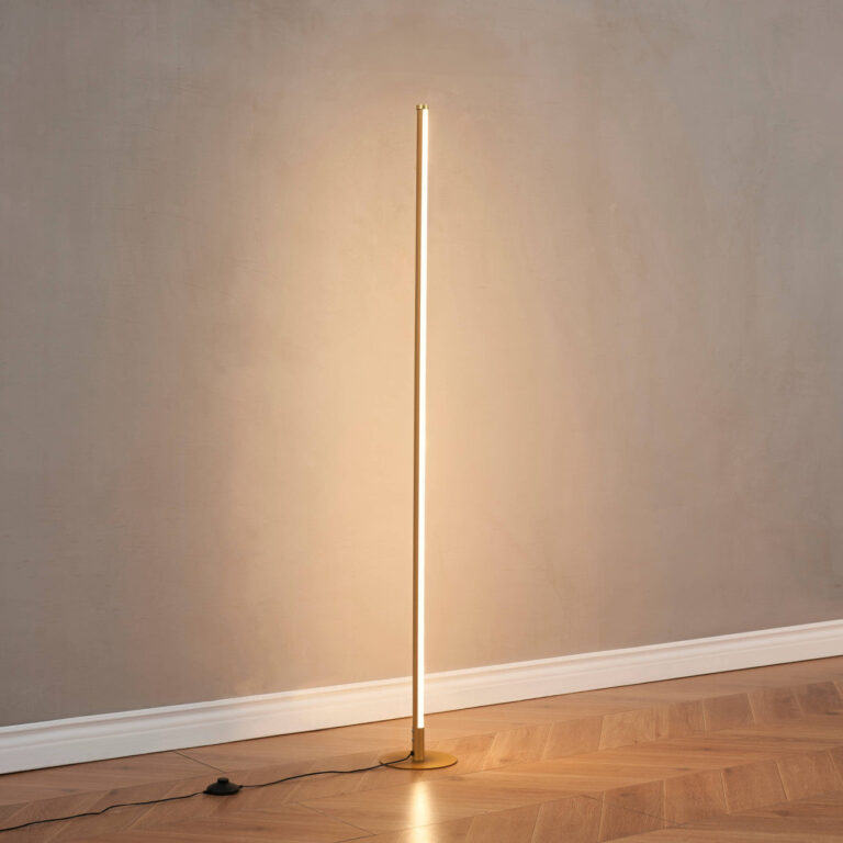 Feature view of gold LED floor lamp with a compact round base