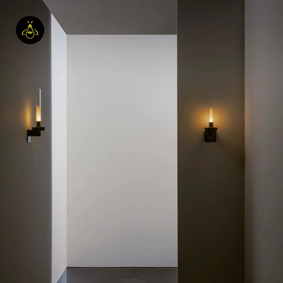 Black Glass Wall Light – Candle-Style Pyrex Glass Tube Sconce, Glossy Black, 46 cm 3 Pair of black glass wall lights lit in a corridor for ambient hallway lighting