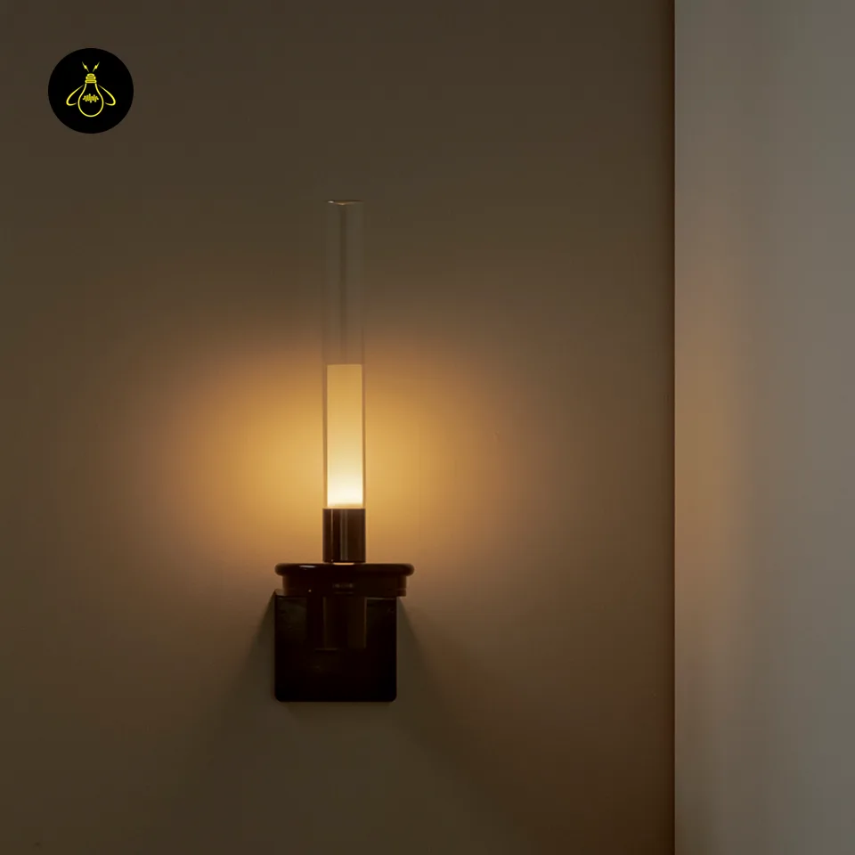 Black Glass Wall Light – Candle-Style Pyrex Glass Tube Sconce, Glossy Black, 46 cm 6 Black glass wall light casting a soft diffused warm halo on the wall