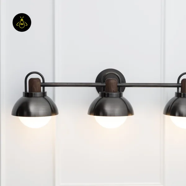 Close-up of vanity wall light: matte black stainless steel arms, turned walnut collars and round central backplate