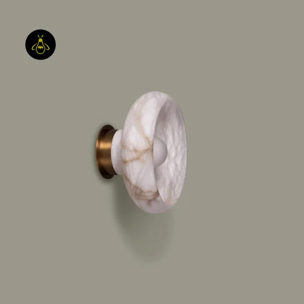 Side view of the round wall sconce: veined alabaster dish and stone collar on a brass-finish round backplate