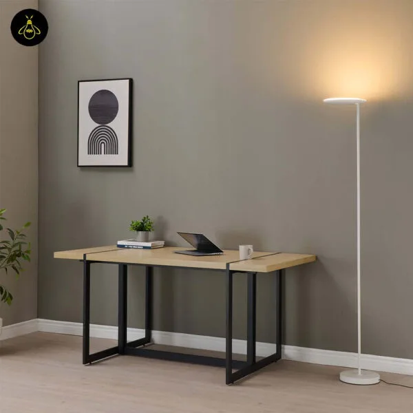 White LED floor lamp with adjustable head placed beside a desk and wall art