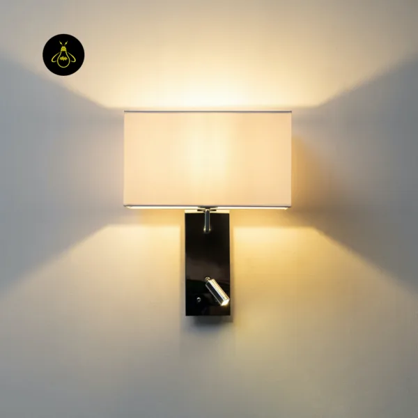 Wall mounted bedside light giving warm 3000K light above and below its white fabric shade