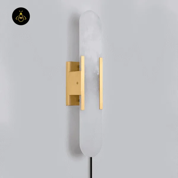 Linear alabaster wall light, unlit, side view of the gold-finish stainless steel frame and backplate