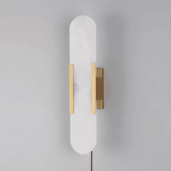 Linear alabaster wall light with gold-finish frame, unlit, side view showing the plug-in cord