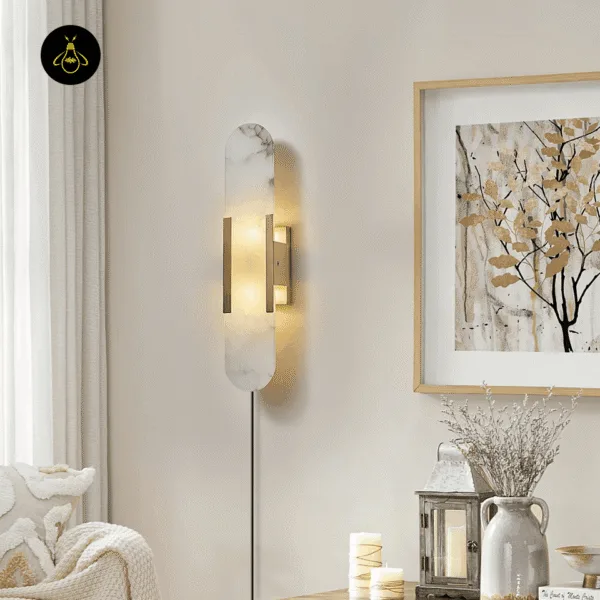 Linear alabaster wall light glowing on a living-room wall above a console with a vase