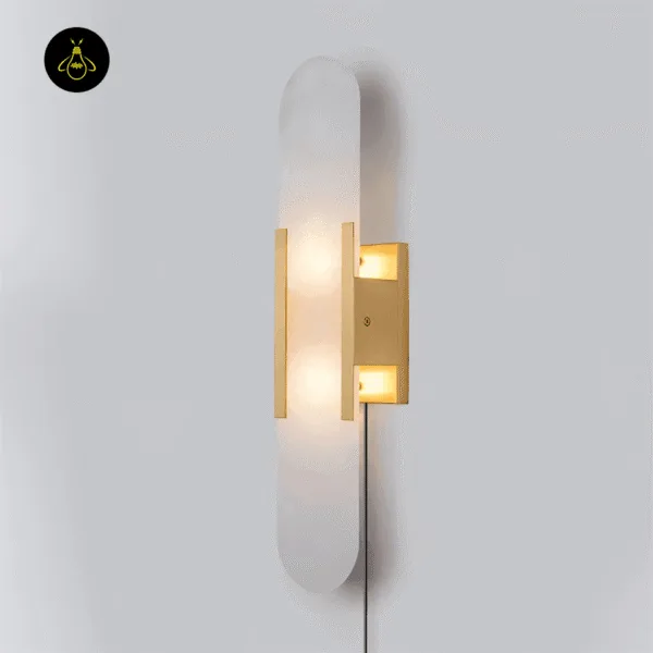 Linear alabaster wall light lit, side view showing the glow through the stone and the plug-in cord
