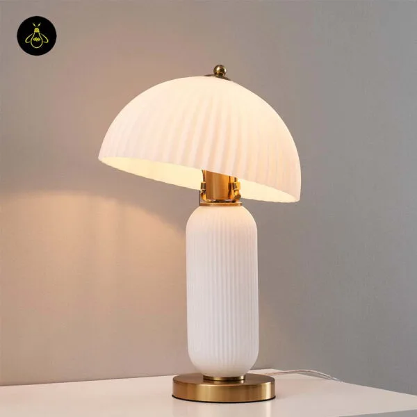 Fluted glass mushroom table lamp on a living room side table
