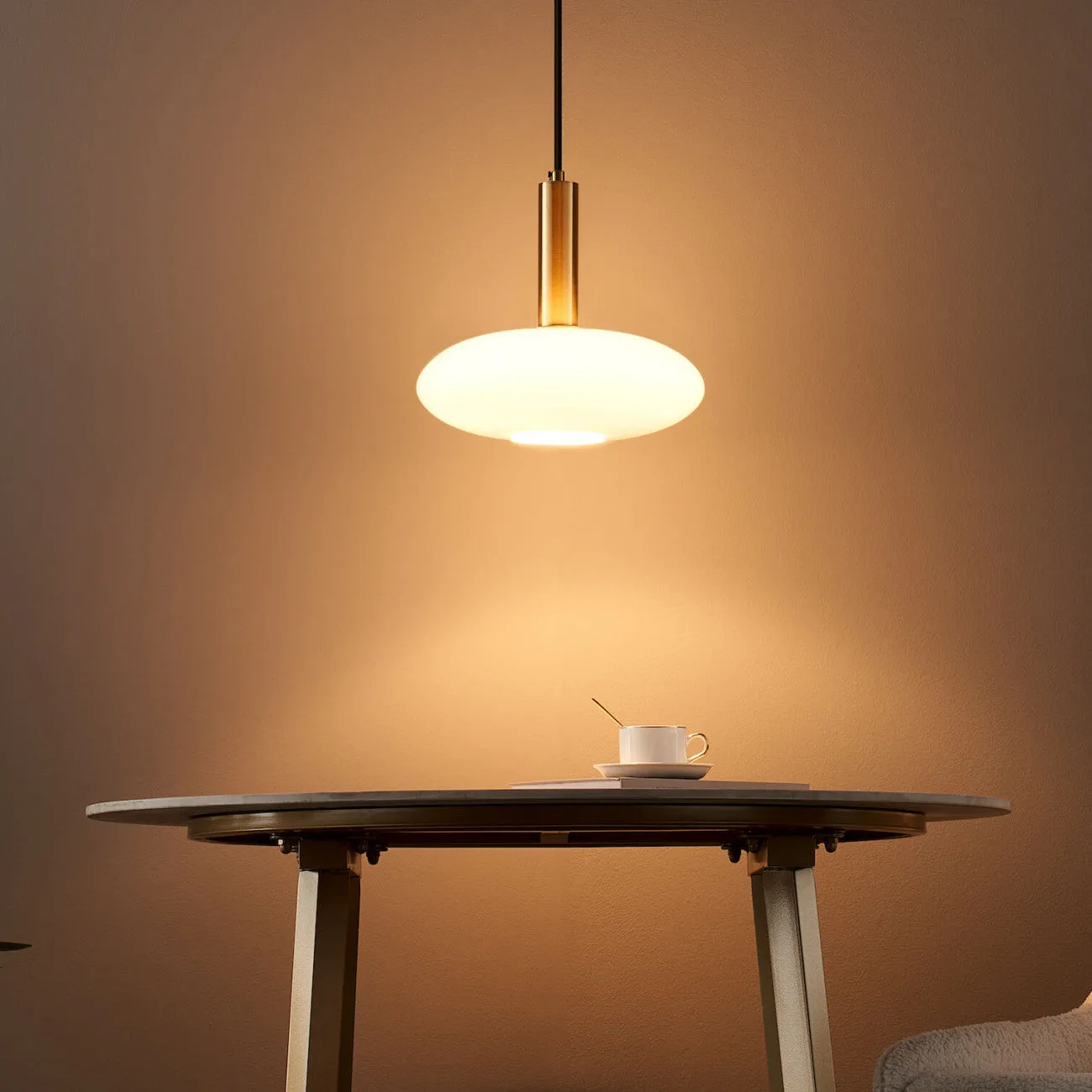 Opaline Glass Pendant Light – Round Brass-Finish Design 9 Opaline glass pendant light hanging over a living room