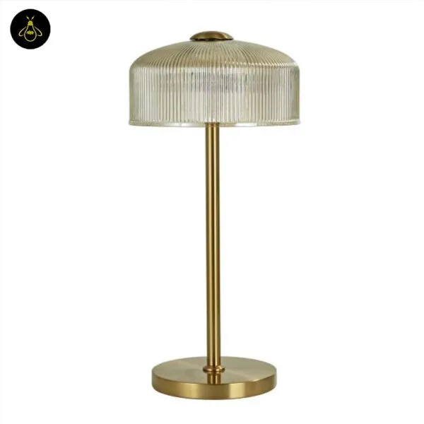 Ribbed amber glass table lamp on a living room console, brass finish