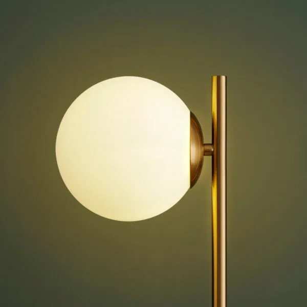 Marble table lamp with opal borosilicate glass globe lighting an office desk