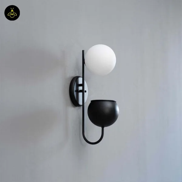 Unlit plant pot wall light on a grey wall: white opal borosilicate glass globe, matte black stainless steel arm and planter cup