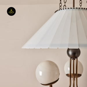 Close-up of a white milk-glass globe on the chandelier arm