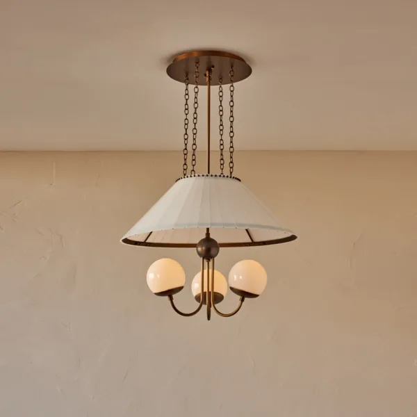 Opal borosilicate glass chandelier with three milk-glass globes and antique brass arms