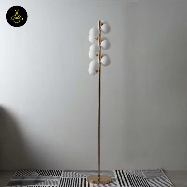 White globe floor lamp unlit showing the G9 12-globe cluster on a slim gold pole and disc base