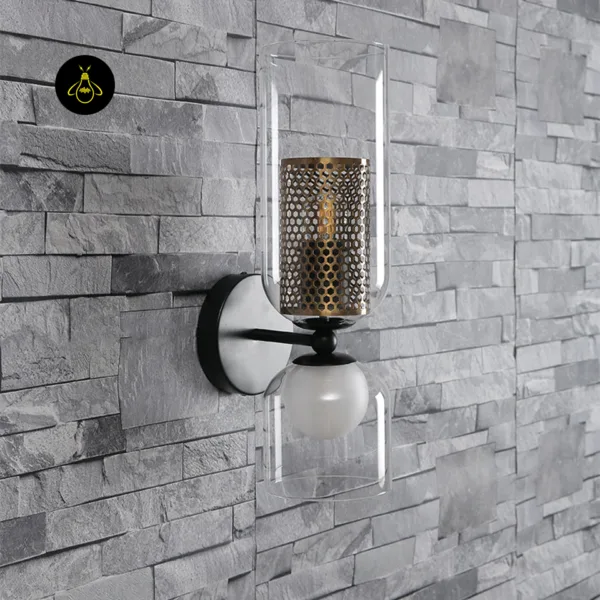 Double wall light on a grey stone-clad wall, matte black stainless steel arm with clear glass shades
