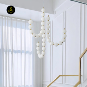 Modern draped pearl chandelier design with cascading opal glass orbs