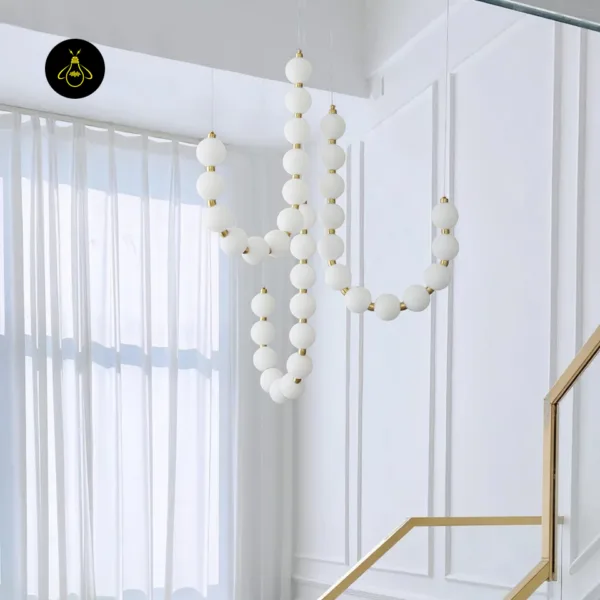Modern draped pearl chandelier design with cascading opal borosilicate glass orbs
