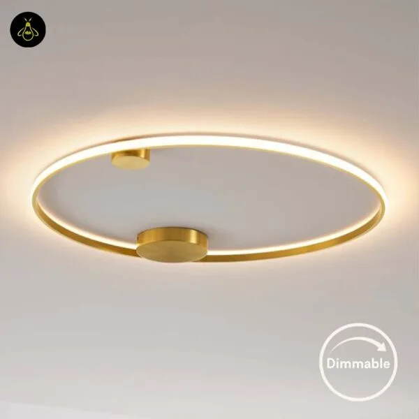 Modern brass LED ceiling ring in a living room