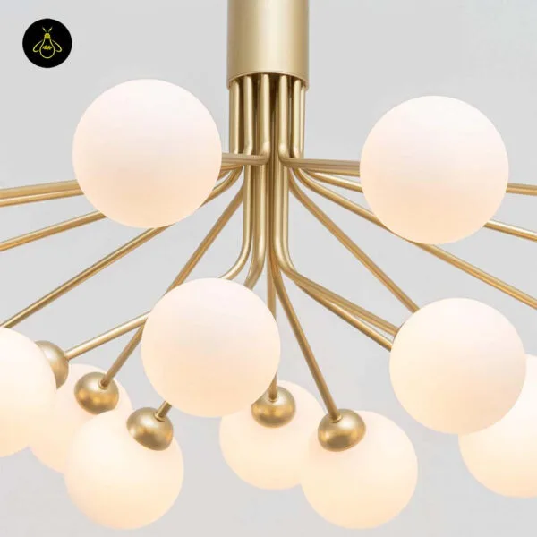 Detail of the gold central column and radiating arms of the modern glass ball chandelier