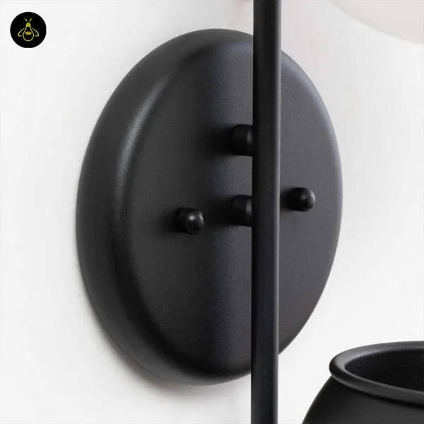 Close-up of the plant pot wall light round matte black stainless steel backplate and fixing knobs