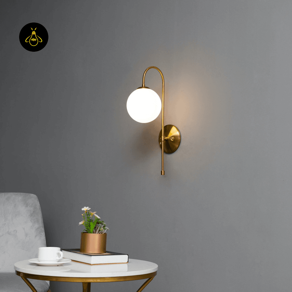 Gold Wall Light for Living Room – Oriol 48 cm Globe Sconce 10 Angled view of the gold Oriol wall light with a curved arm and white frosted globe