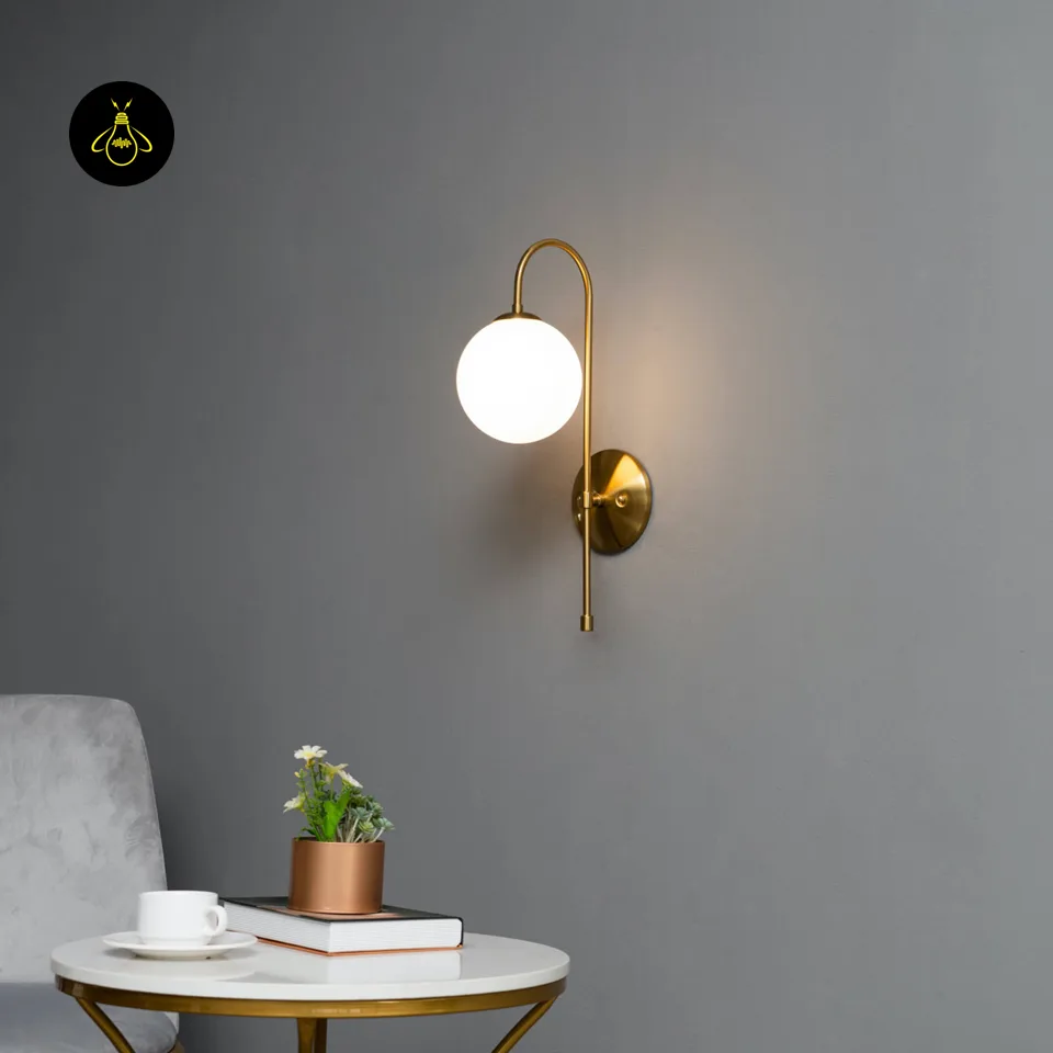 Oriol Frosted Glass Globe Wall Sconce – 48 cm Antique Gold Arch | Jagmag Lights 10 Angled view of the gold Oriol wall light with a curved arm and white frosted globe