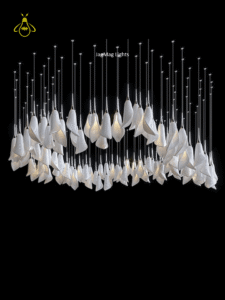 Modern jhumar chandelier showing the square top plate and cascading white glass leaf pendants