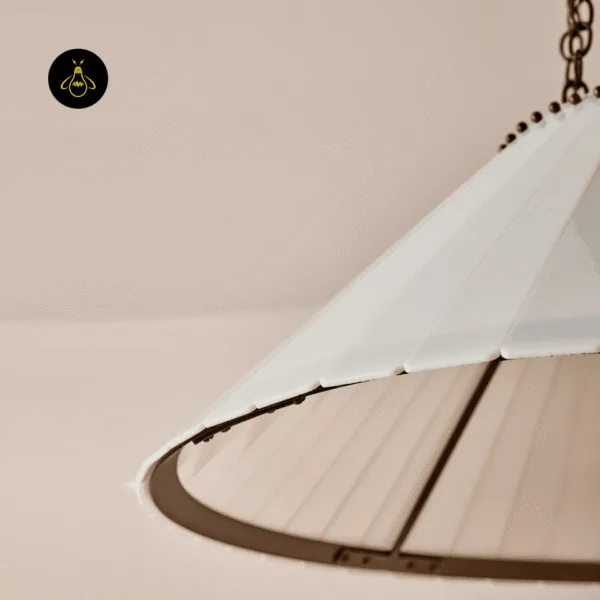 Rim of the vintage glass chandelier pleated cream shade with its antique brass finish ring