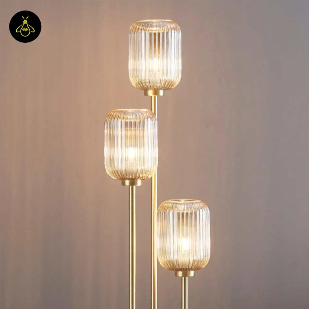 Triple Amber Glass Floor Lamp – 3-Light Gold Ribbed Glass Statement 2 Triple amber glass floor lamp with three ribbed amber shades on a plain background