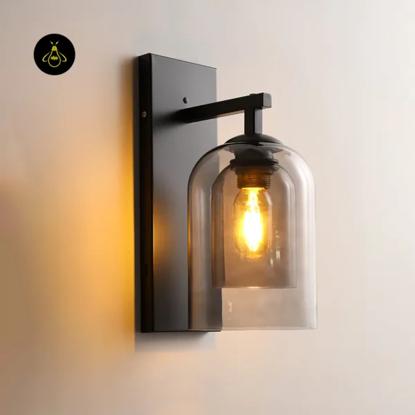 Fancy lights for wall lit on a warm wall: smoked borosilicate glass double shade on a matte black stainless steel bracket