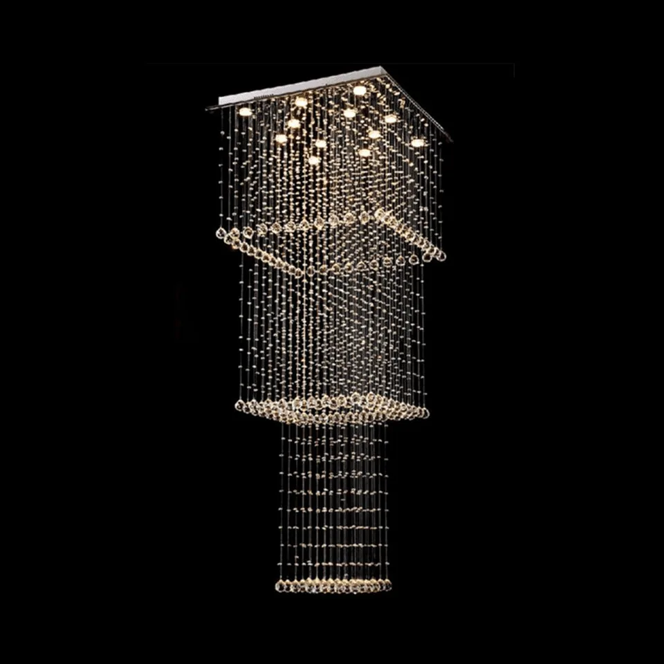 Rectangular raindrop chandelier lit warm white, K9 crystal tiers hanging from a polished steel plate