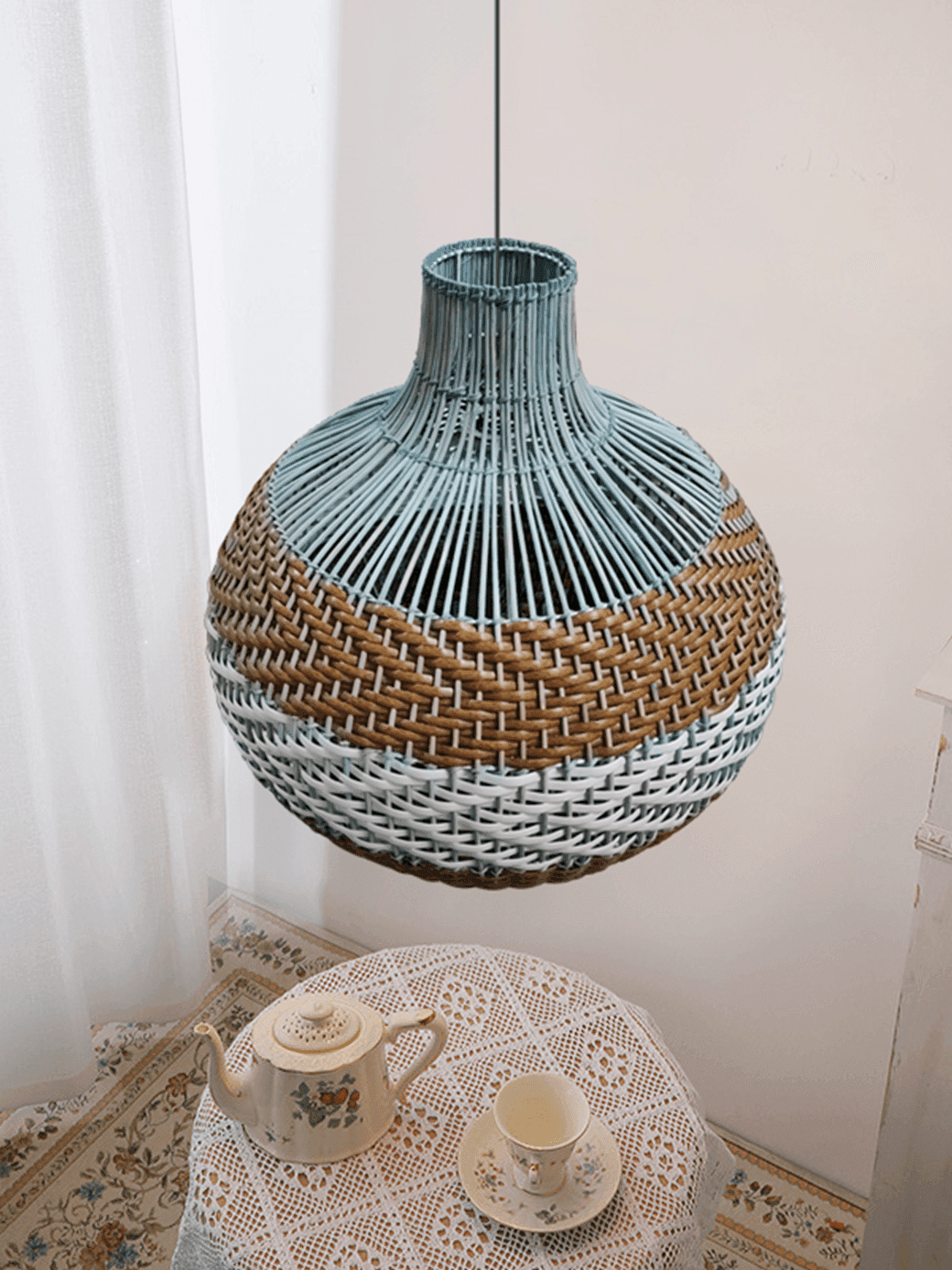 Rattan Hanging Lamp – Handwoven Coastal Pendant, 40 cm 6 Rattan pendant lamp in blue and natural tan over an indoor tea table corner – Jagmag Lights