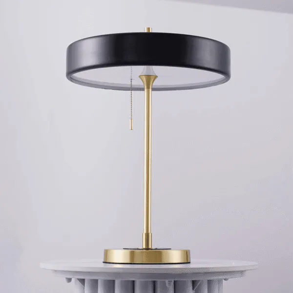 Retro study lamp seen from the side, showing the white diffuser under the black disc and the pull chain