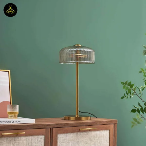 Ribbed amber glass table lamp in a bedroom setting