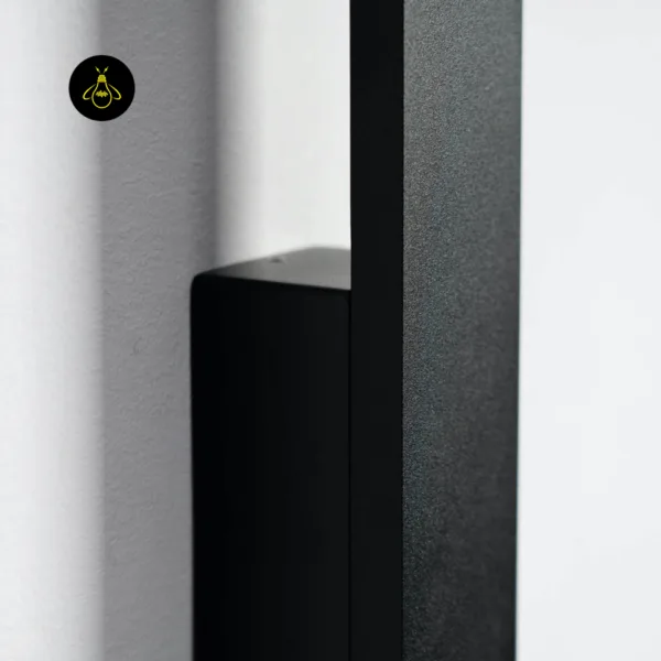 Close-up side view of the slim LED wall light matte black stainless steel bar and its wall-mount block
