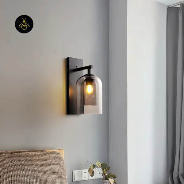 Fancy lights for wall used as a bedside light: smoked borosilicate glass sconce on matte black stainless steel above a headboard