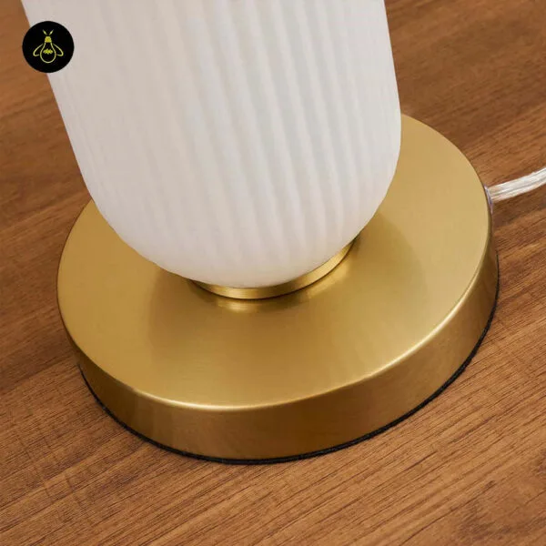 Brushed brass round base of the white fluted glass mushroom table lamp