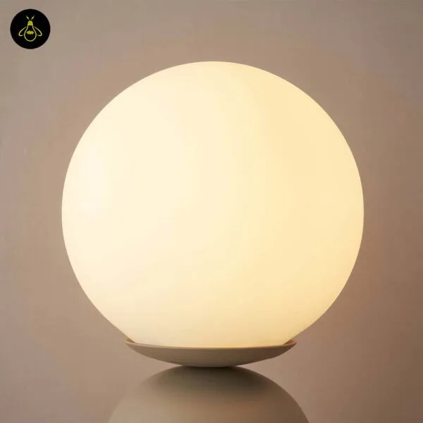 Compact taupe table lamp with white globe and capsule base design
