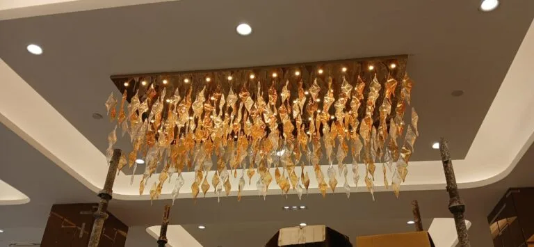 Tall twisted glass leaf chandelier inside SKA Orion interior