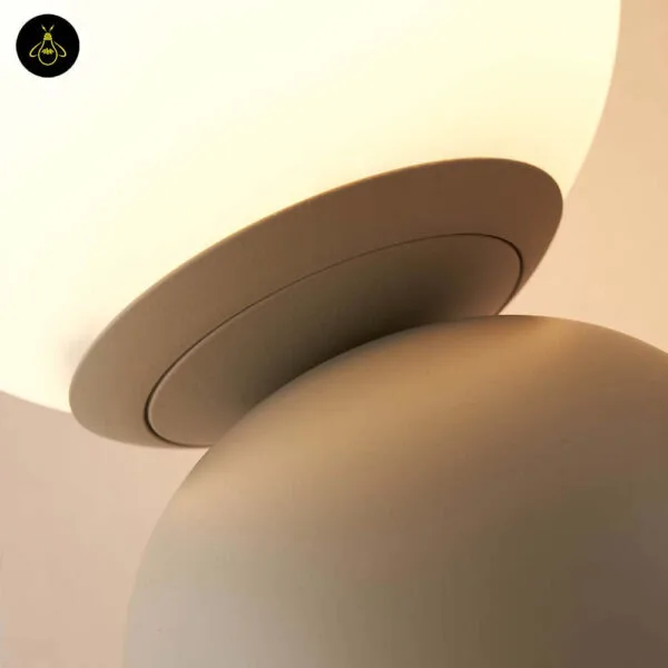 Taupe table lamp with white globe on a living room console table