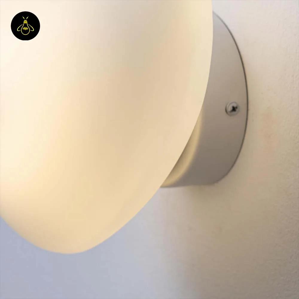 White Opaline Wall Light – Veglia 25 cm Glass Disc 3 White LED wall light casting a calm warm glow in a bedroom