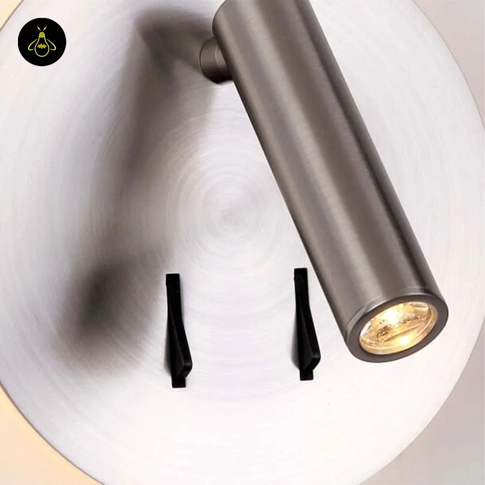 Wall Mounted Reading Light – LED Double Light, Chrome Finish 8 Close-up of the wall lamp for bedroom: circular brush lines on the steel disc, LED reading spot and two switches