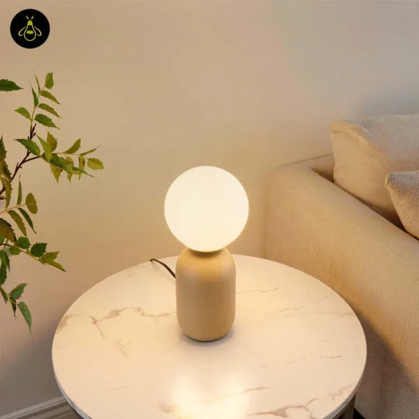 Opal borosilicate glass globe shade of the taupe table lamp in close up