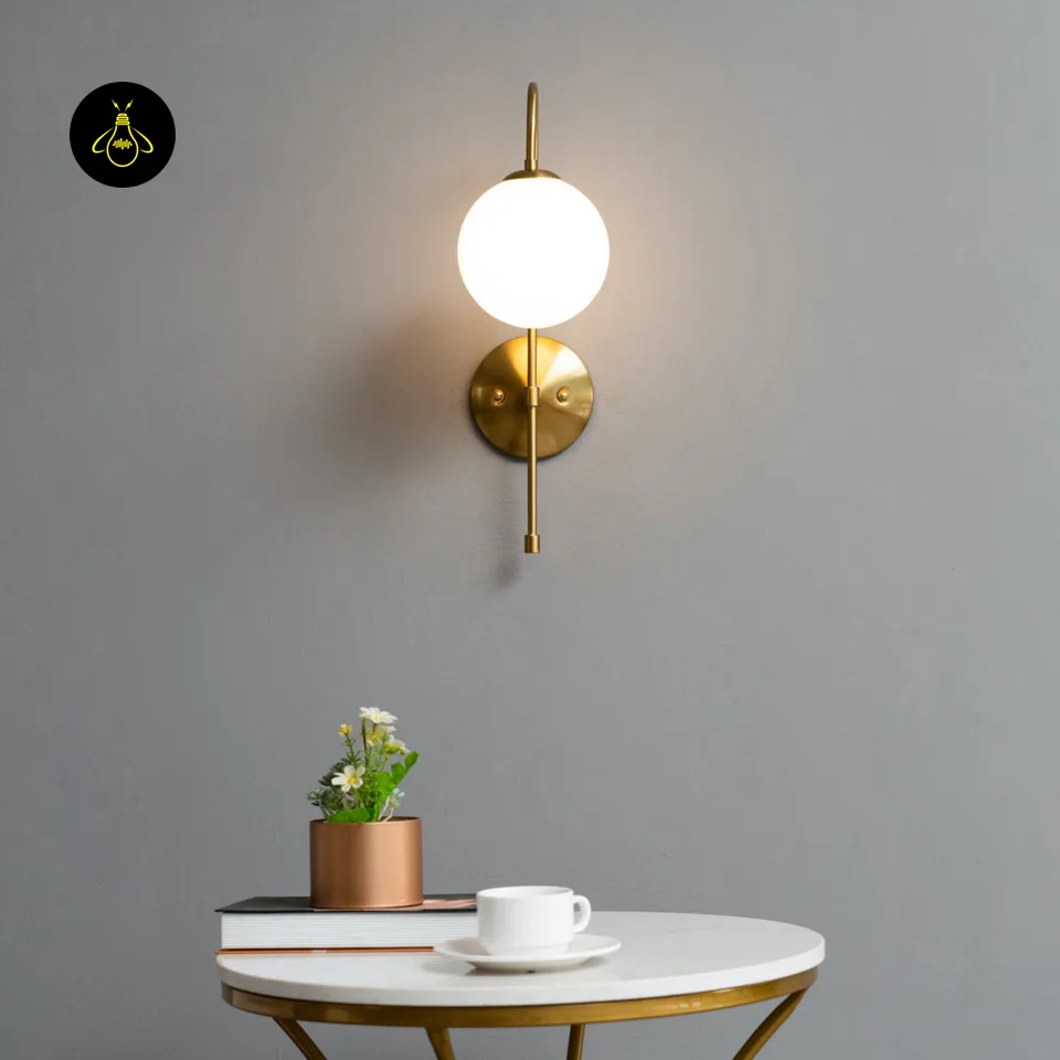 Oriol Frosted Glass Globe Wall Sconce – 48 cm Antique Gold Arch | Jagmag Lights 13 Opal borosilicate glass globe and gold metal cap close-up of the living room wall light