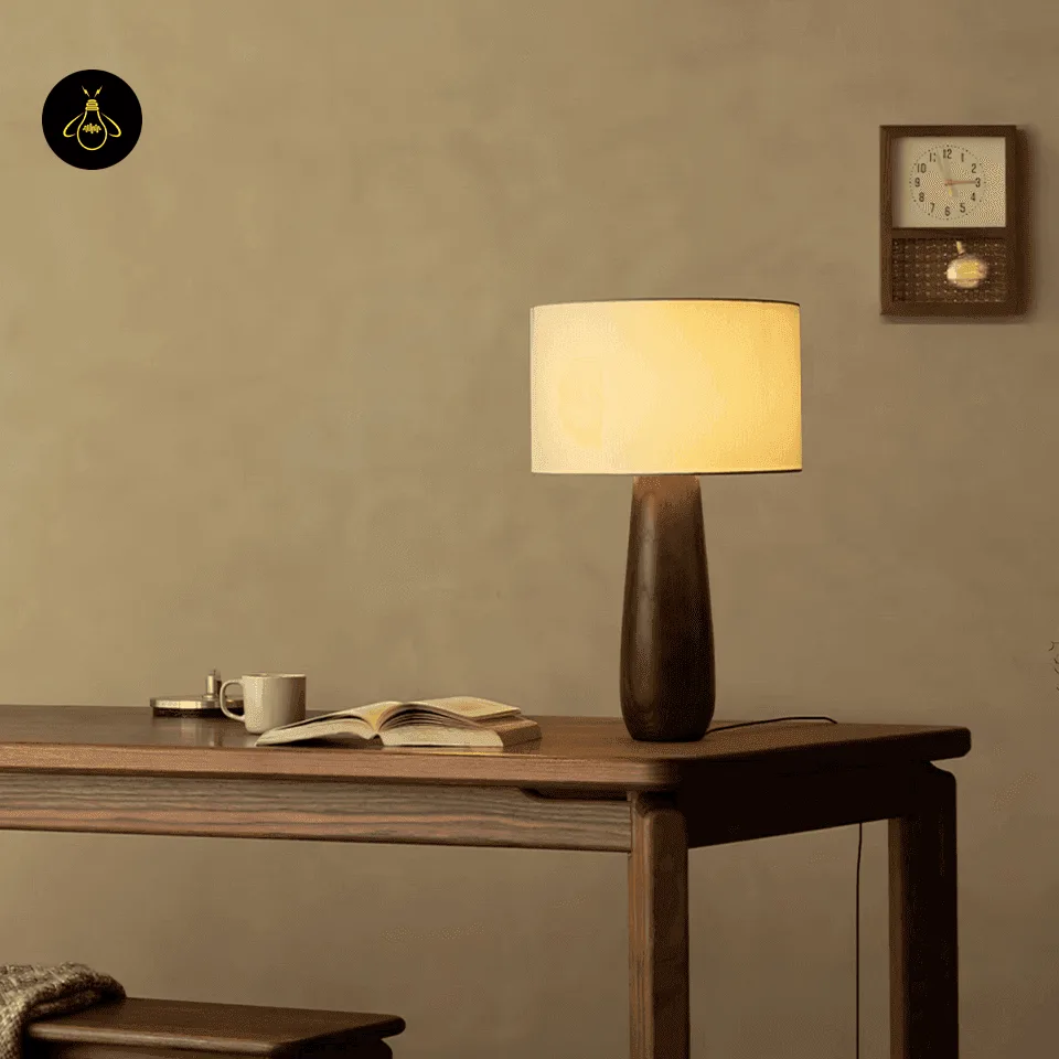 Wooden Bedside Lamp – Sierra Turned-Wood Table Lamp with Linen Shade 6 Dark-toned wooden bedside lamp lighting a walnut study desk with an open book and a cup