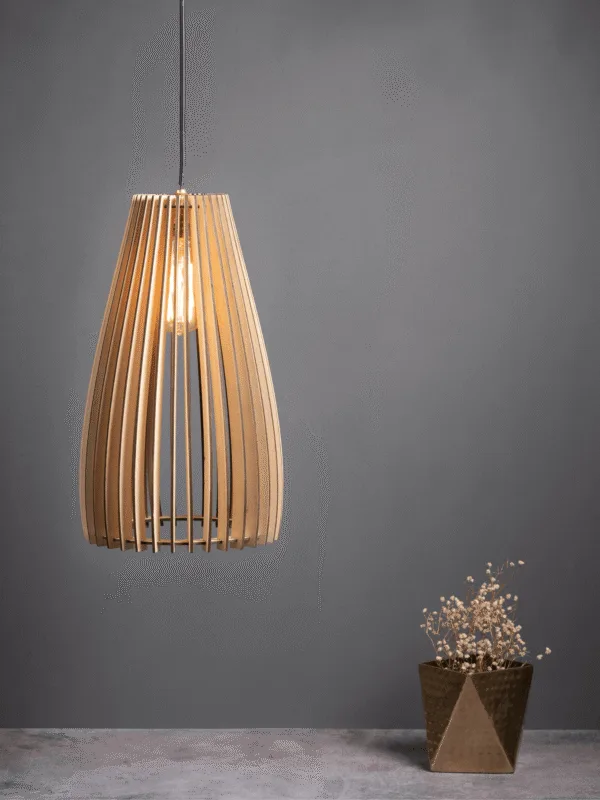 Wooden hanging light lit warm against a grey wall, birch plywood ribs glowing above a brass pot of dried flowers