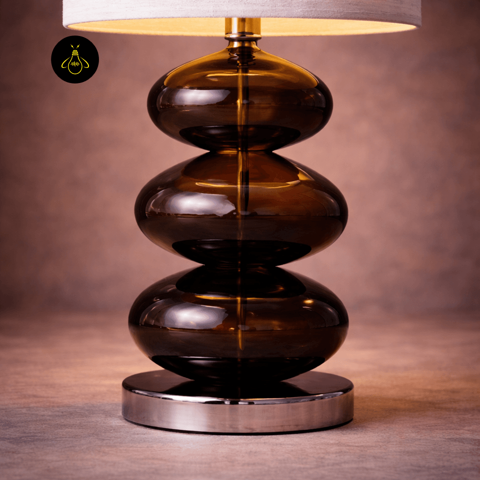 Glass Table Lamp – Amber Stacked-Pebble Base, 52 cm 5 Close-up of amber glass table lamp on a polished chrome base